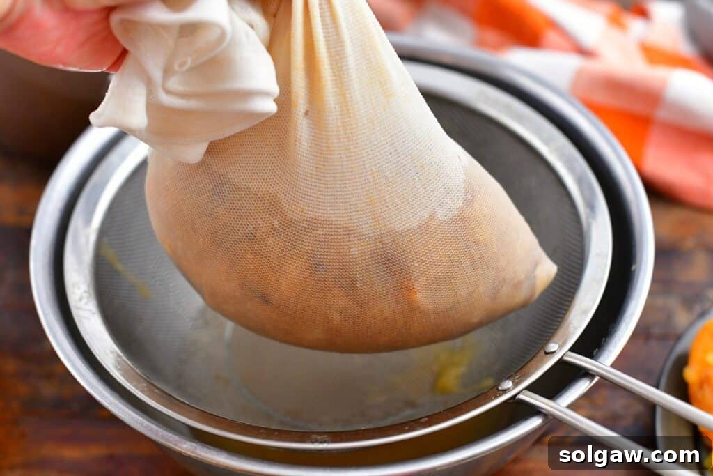 Wholesome Homemade Apple Cider 7 mashing apples in cheesecloth to make cider