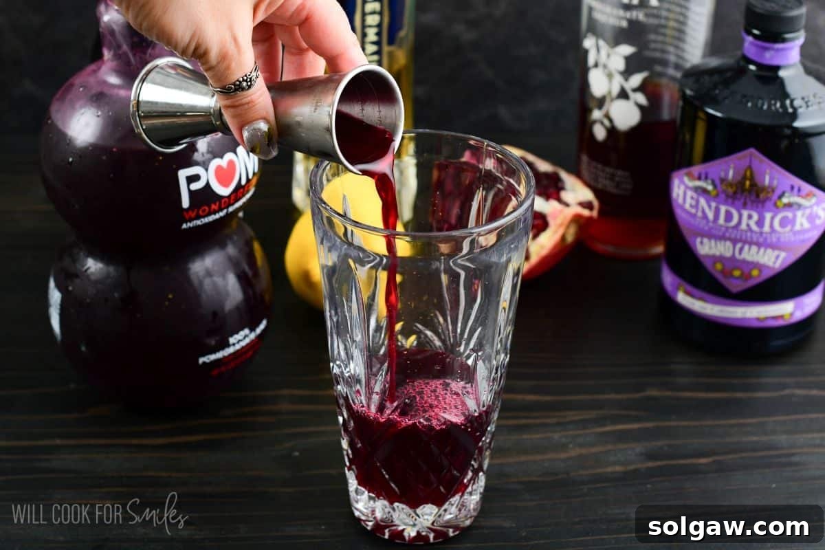 adding rich and fruity pomegranate juice to the cocktail shaker.