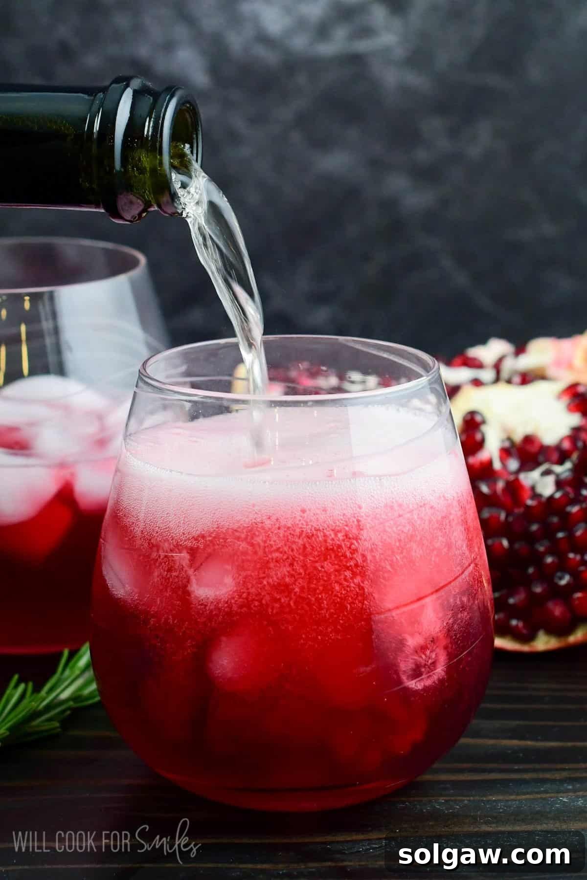 topping the gorgeous deep red gin cocktail with some bubbly prosecco.