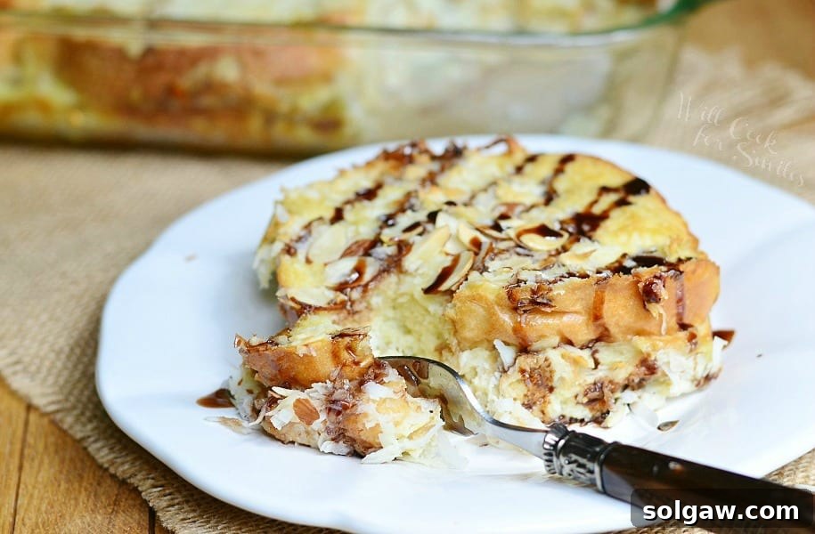Almond Joy French Toast Bake with a fork, showing the moist interior and toppings