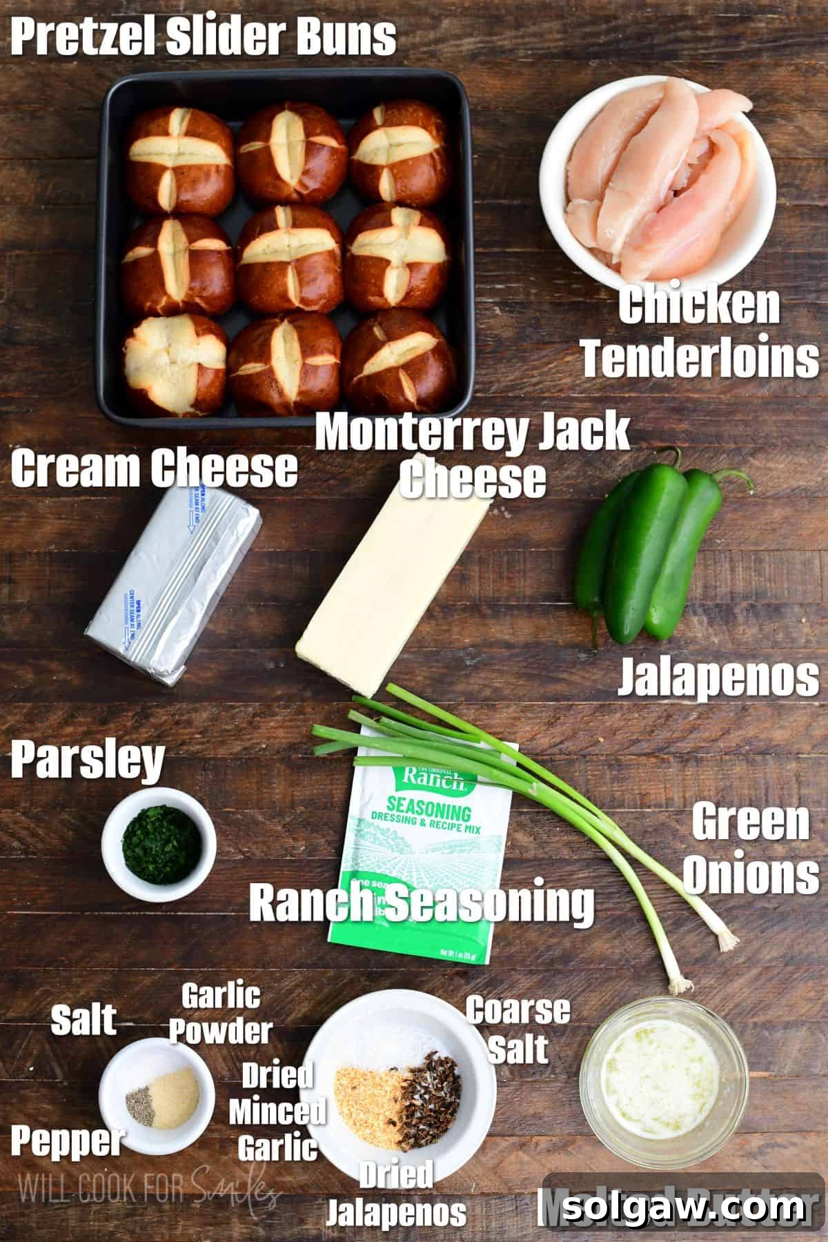 Labeled ingredients for jalapeño ranch chicken sliders on a wood surface, showcasing fresh produce and cheeses.