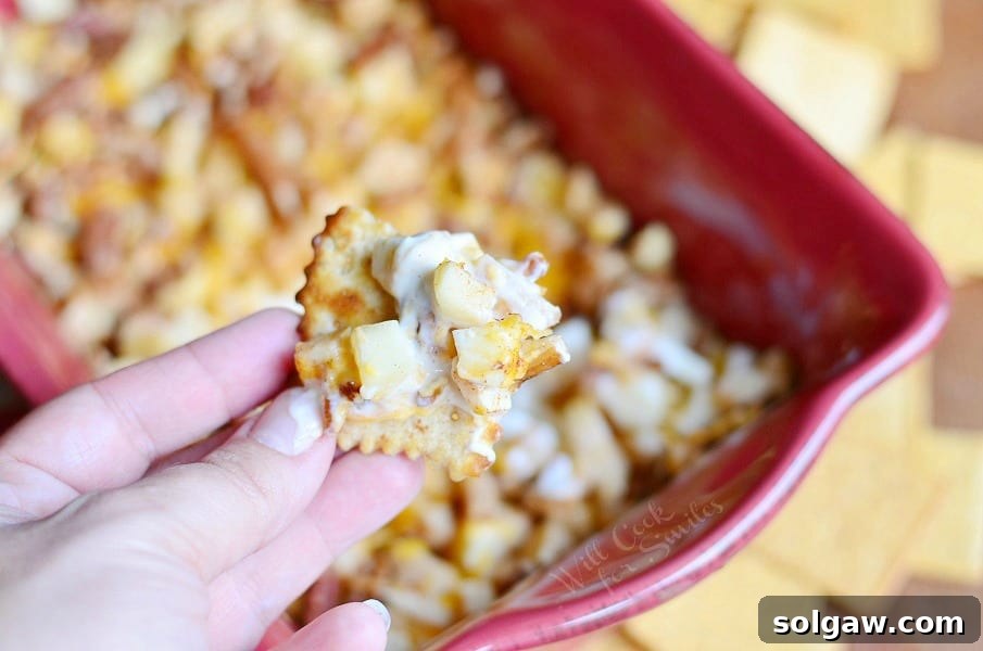 Master Your Next Party: Hot Apple Pie Dip and 9 Brilliant Hosting Ideas 5 Hot Apple Pie Dip elegantly served with a variety of dippers, including crackers and fresh apple slices, on a wooden board.