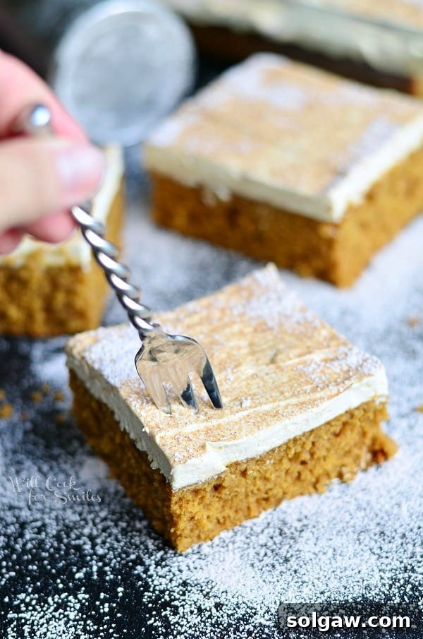 Close-up of a slice of Gingerbread Cake showing its moist texture and rich frosting.