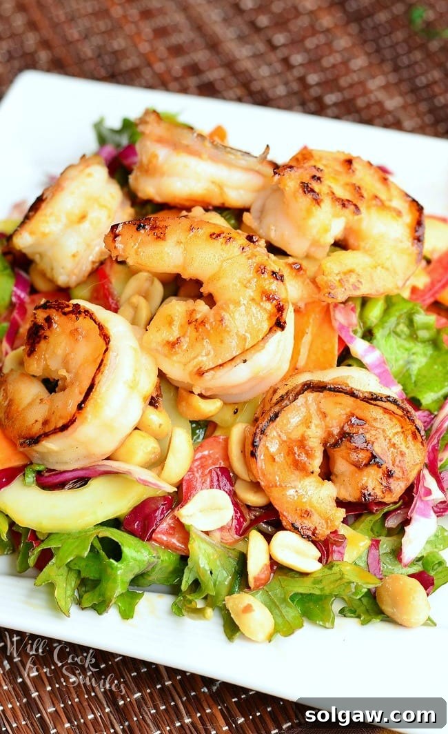 Zesty Thai Shrimp Salad with Creamy Peanut Dressing 7 Vibrant Thai Shrimp Salad with Peanut Dressing artfully presented on a plate, highlighting its fresh ingredients and enticing flavors