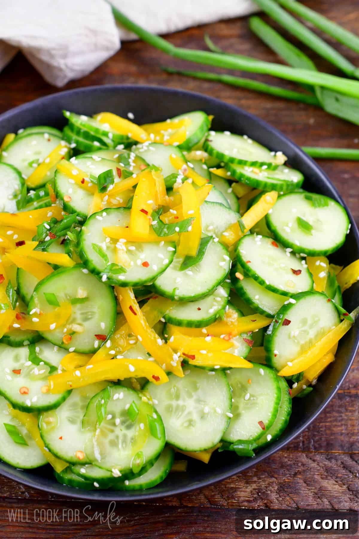 Asian cucumber salad mixed with dressing in a serving bowl.