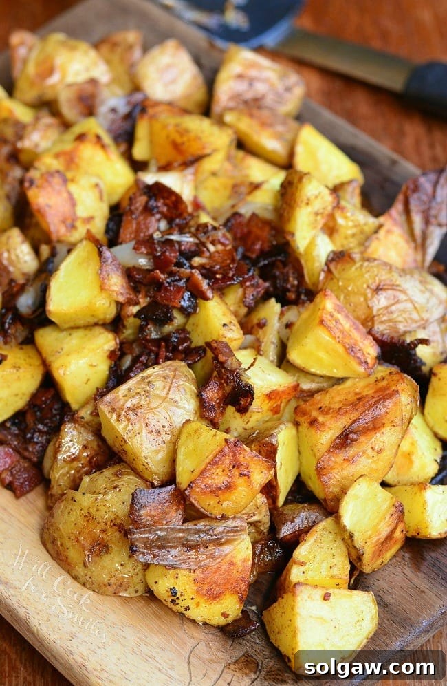 Roasted Potatoes with Bacon and Pearl Onions on a wood cutting board