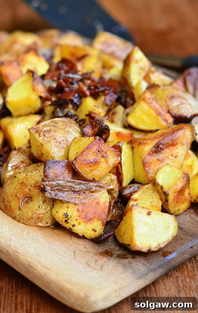 Roasted Potatoes with Bacon and Pearl Onions on a wood cutting board