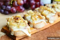 Sweet and Savory Brie Crostini with Caramelized Onions, Pear, and Pine Nuts