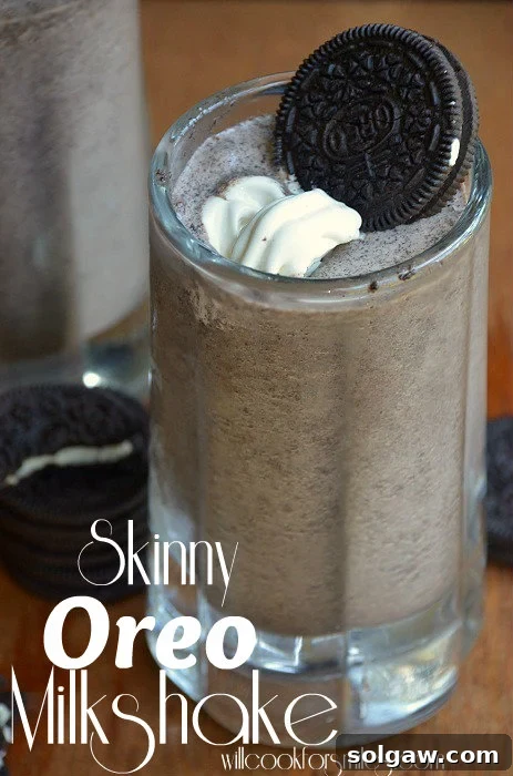 Oreo Milkshake in a glass mug with whipped cream and an oreo as garnish