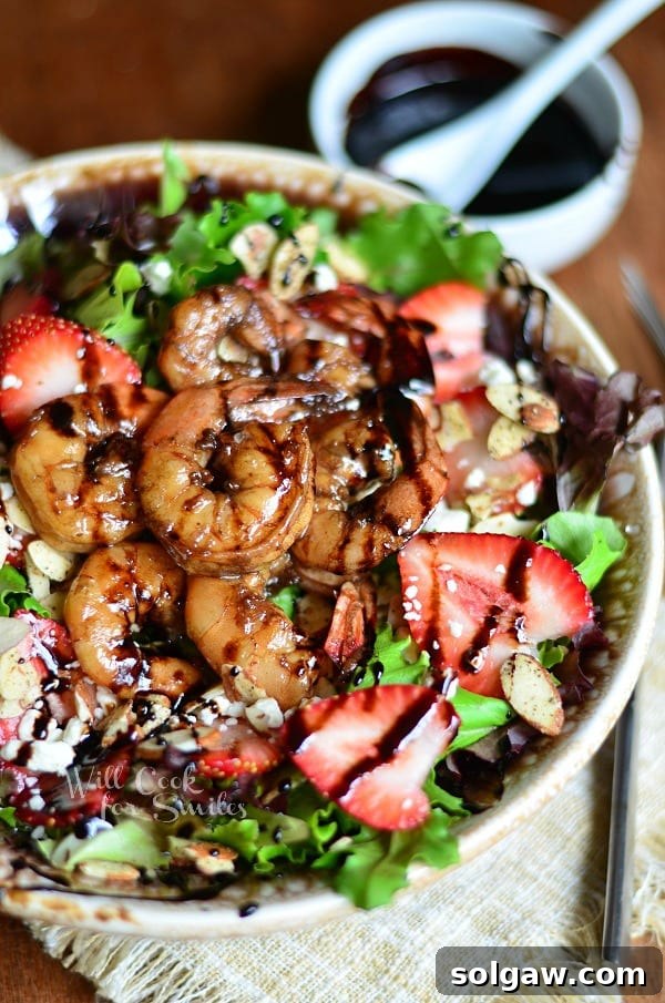 Balsamic Shrimp Salad in a bowl with strawberries and feta cheese