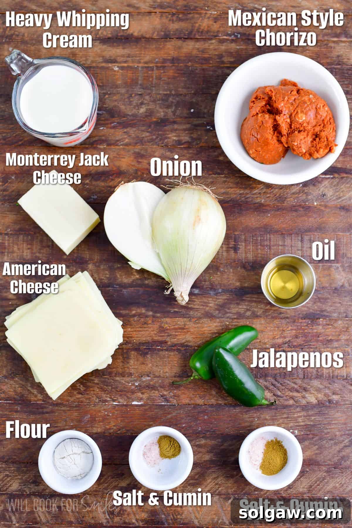 A selection of fresh ingredients including Mexican chorizo, Vidalia onion, and jalapeno peppers, neatly arranged on a wooden table, ready to be prepared for Queso Blanco with Chorizo.
