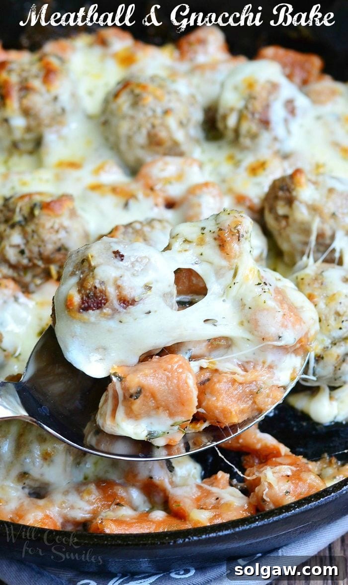 Hearty Meatball Gnocchi Casserole 2 Meatball and Gnocchi Bake with cheese on top on a cast iron skillet, ready to serve