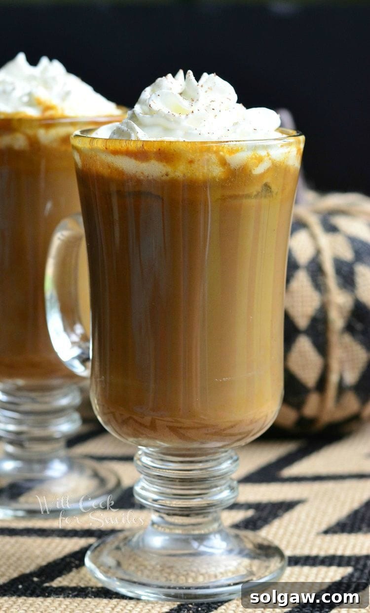 Autumn White Mocha Delight 2 Pumpkin White Chocolate Mocha Latte in a clear glass cut with whip cream on top