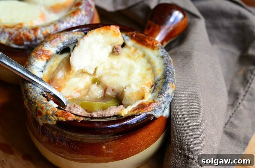 Philly Cheese Steak Soup bowl with a spoon inside it 