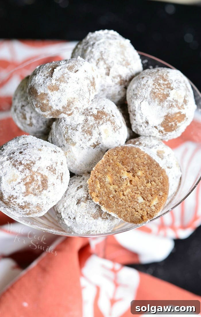 Pumpkin Spice Rum Balls with powder sugar on the outside of them in a champagne glass