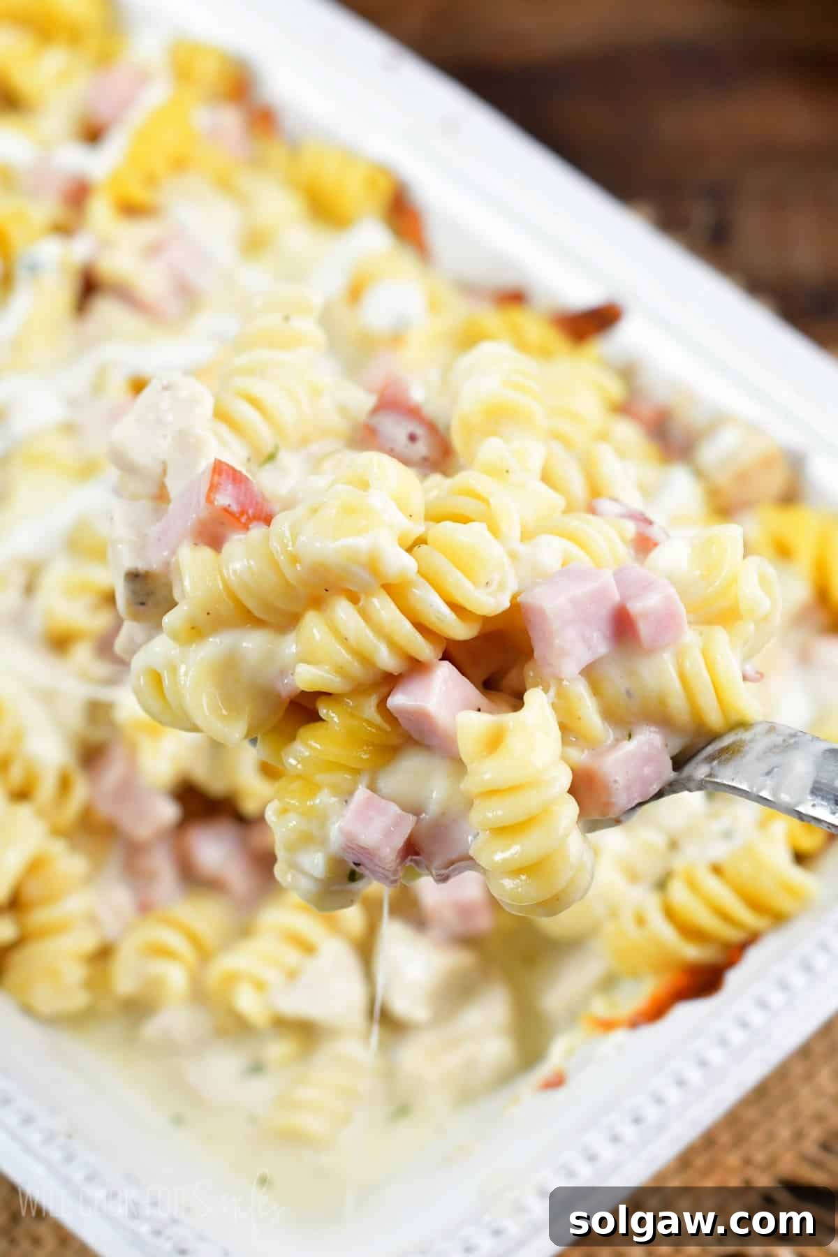 Chicken Cordon Bleu Chicken Casserole on being scooped up with a spoon.