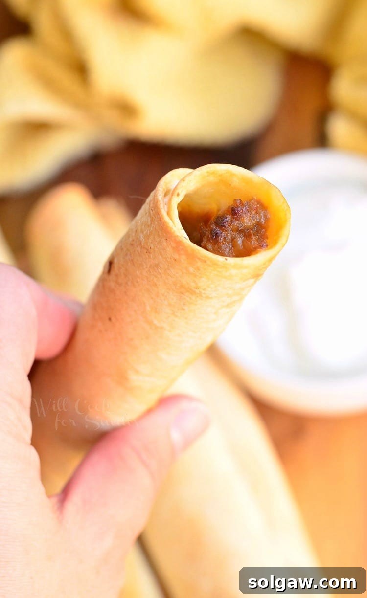 Holding a Jalapeño Sausage and Cheese Taquitos