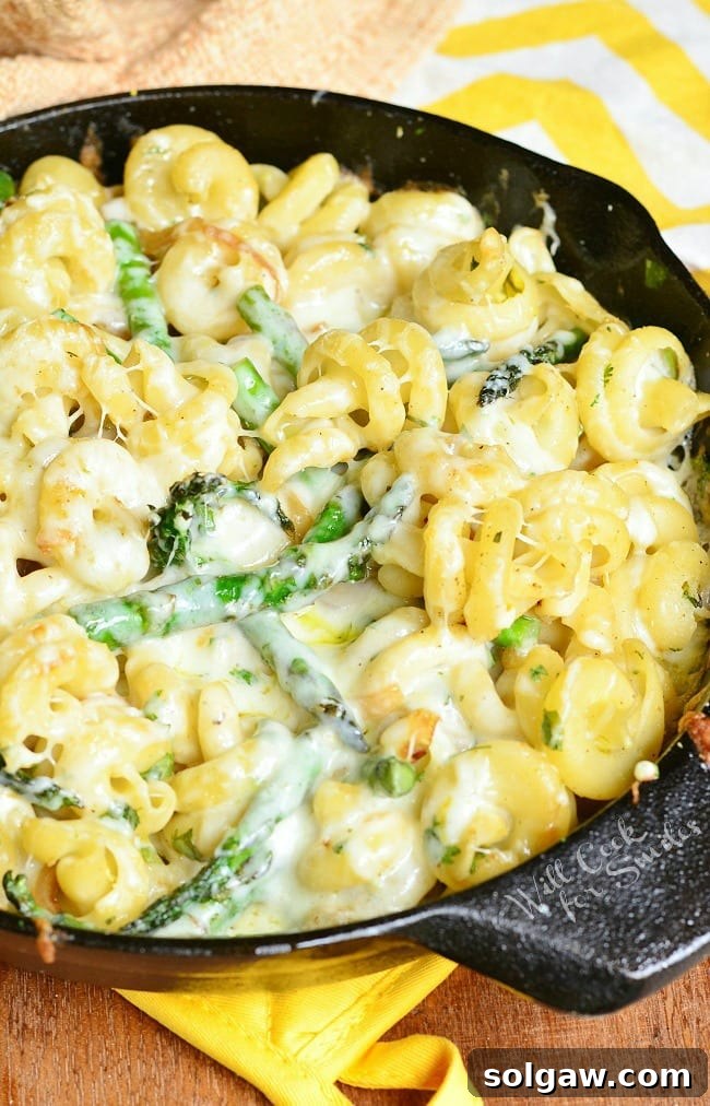 Extra Cheesy Lemon Asparagus Pasta Skillet, cooked and served directly in a cast iron skillet.