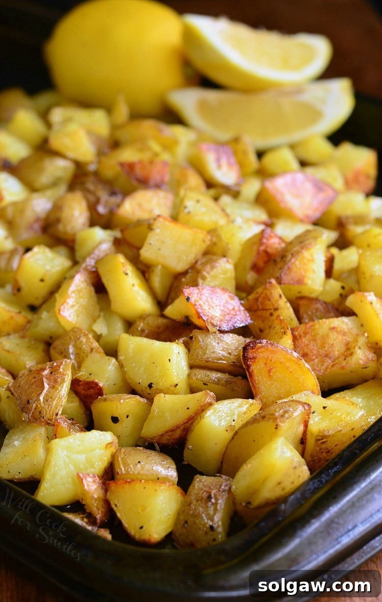 A close-up view of Truffle Lemon Pepper Roasted Potatoes on a baking sheet, showcasing their golden crispiness.