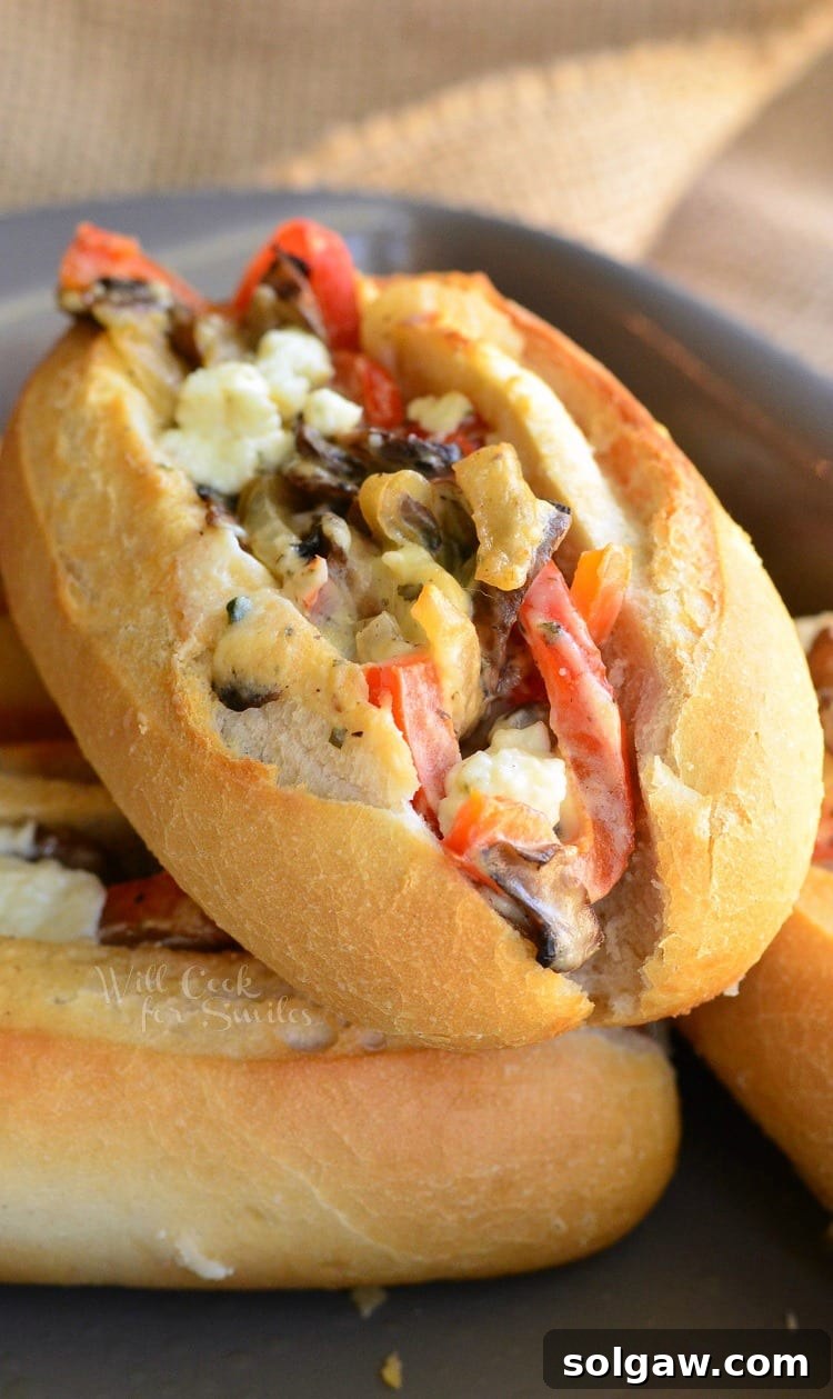 Close-up of Baked Mini Veggie and Cheese Sandwiches with golden-brown crusts and visible melted cheese and vegetables.