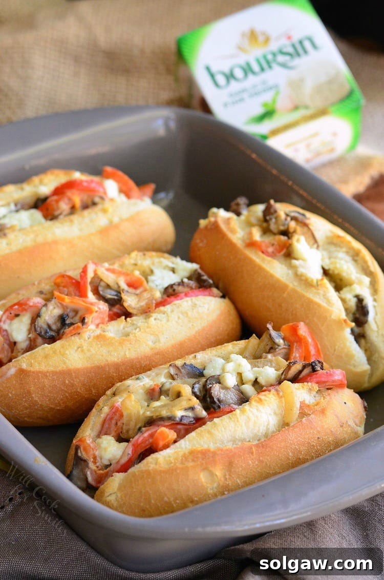 A close-up of a single Baked Mini Veggie and Cheese Sandwich, held in hand, showing the warm, cheesy filling.