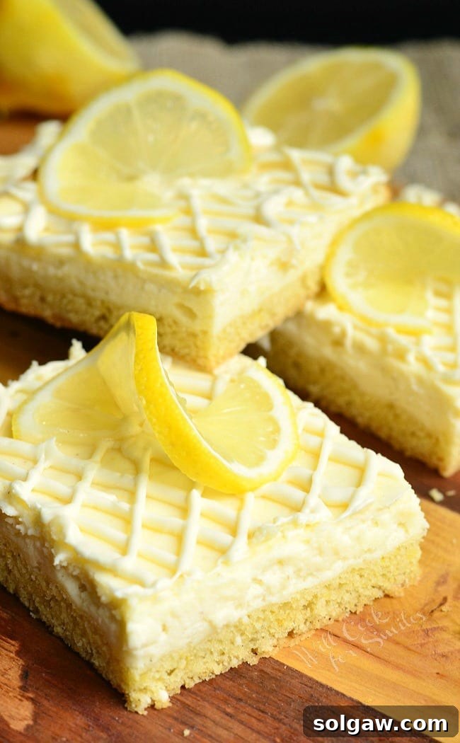 Vanilla Bean Lemon Cheesecake Bars with lemon slice garnish