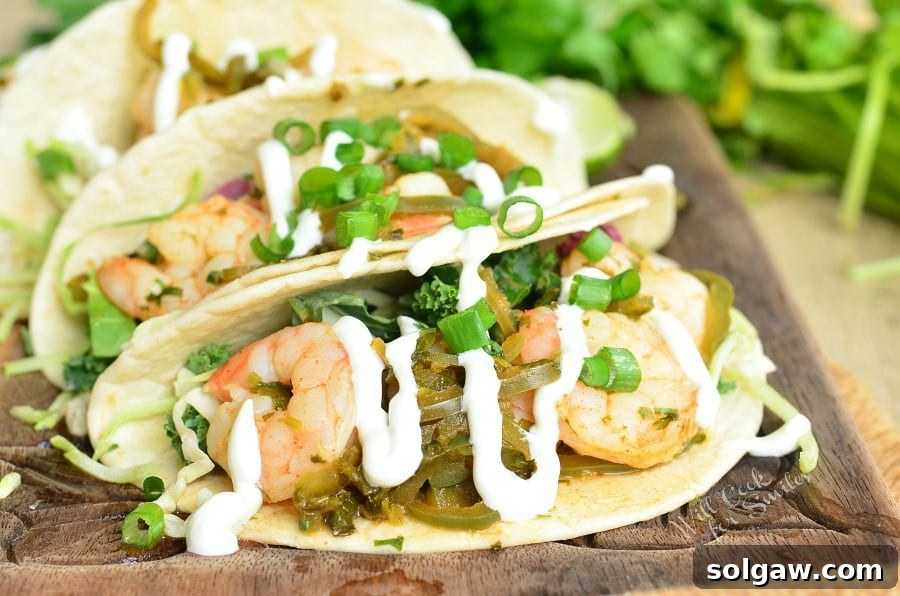Tequila Lime Shrimp Tacos with sour cream and green onions on top