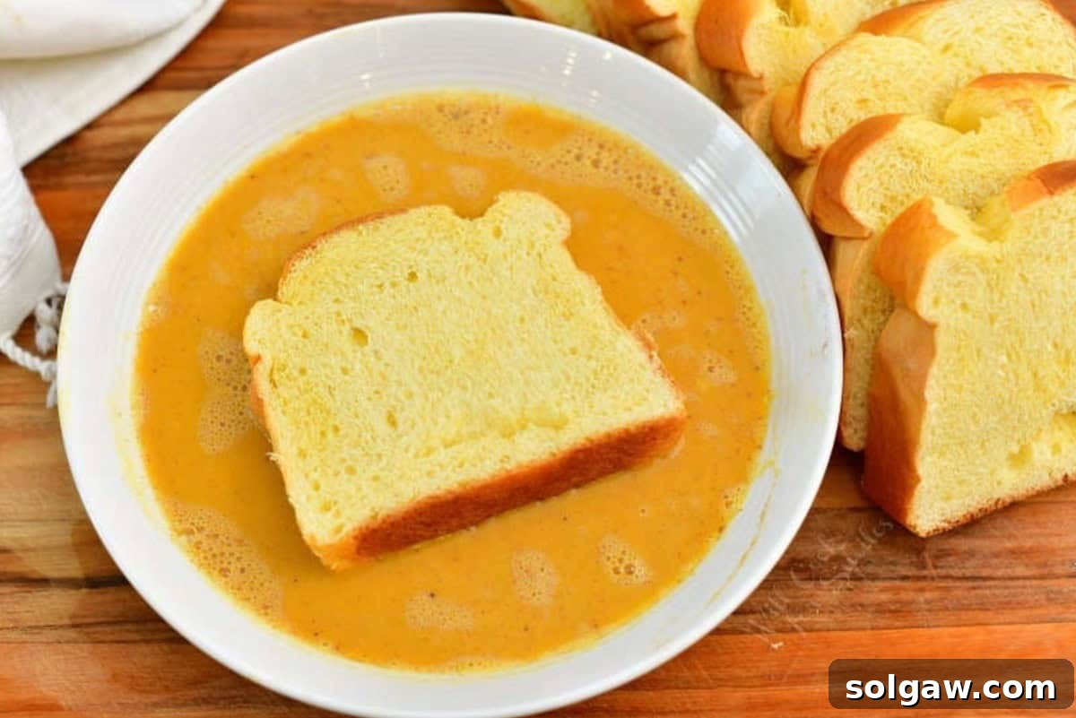 Spiced Pumpkin French Toast 4 soaking Brioche bread slices in a pumpkin egg mixture.
