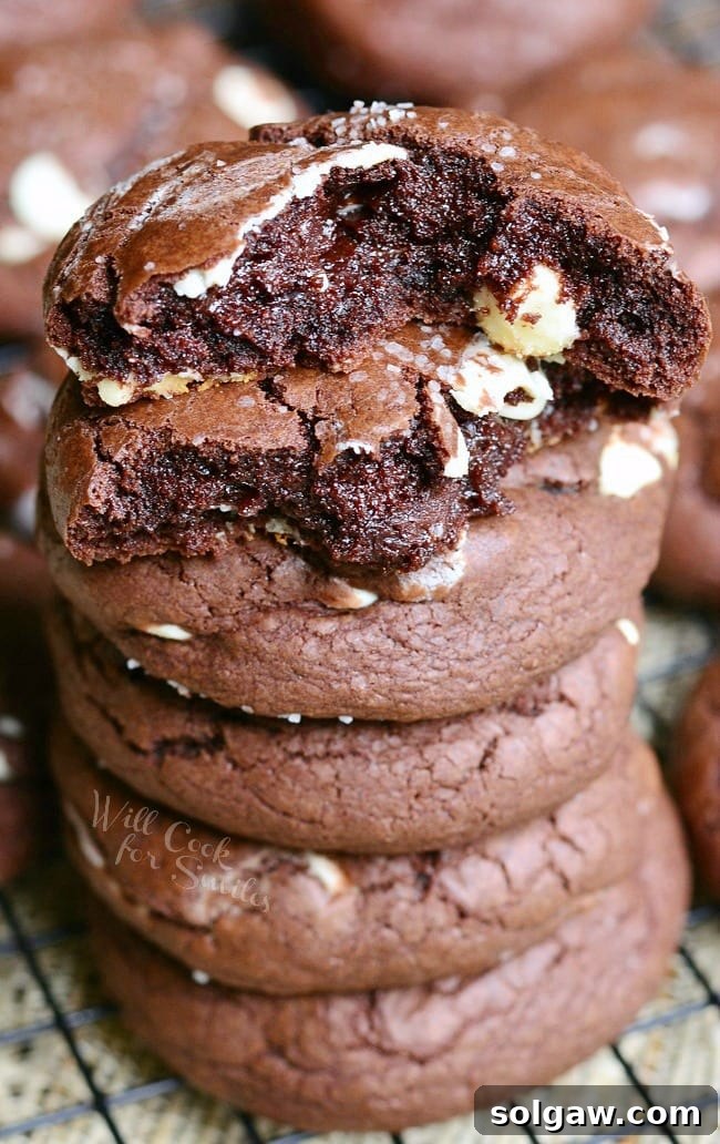 Salted Chocolate White Chocolate Chip Cookies stacked up with the top torn in half