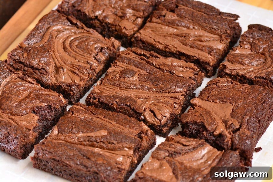 sliced up Nutella brownies on parchment paper, ready to be served.