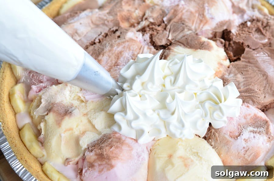 Piping whipped cream on top of vanilla, strawberry, and chocolate ice cream