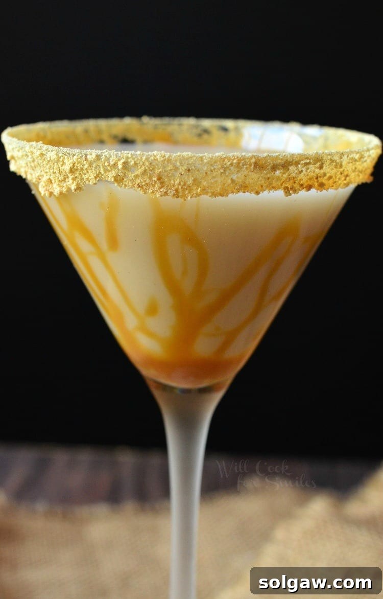 Martini glass filled with caramel cake martini and a graham cracker rim