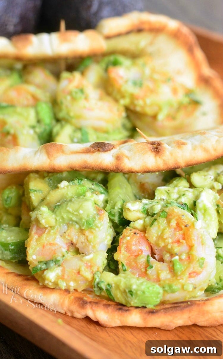 A close-up shot of an Avocado Shrimp Flatbread Sandwich, showing off its fresh ingredients