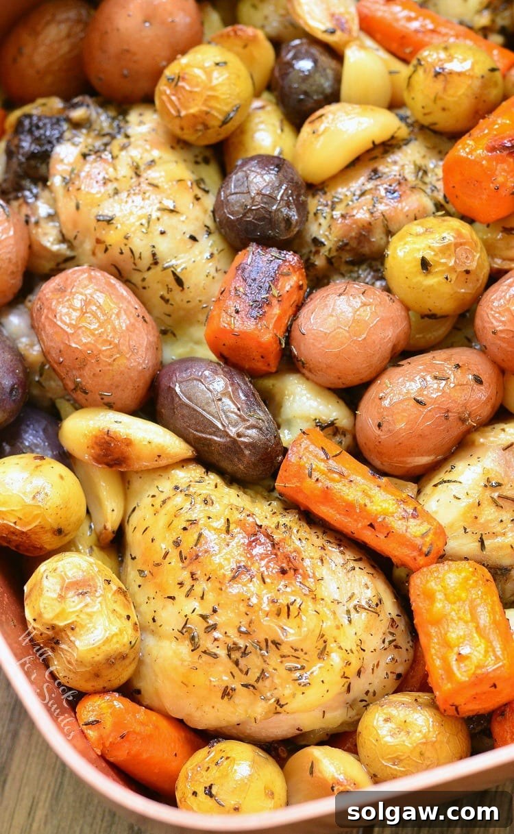 Chicken Drumsticks, garlic, potatoes, and carrots in a pan