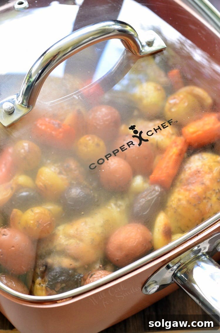 Chicken Drumsticks, garlic, potatoes, and carrots in a pan with the lid on top 