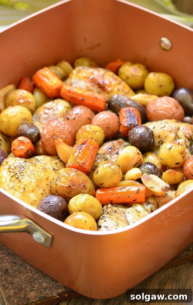 Chicken Drumsticks, garlic, potatoes, and carrots in a pan