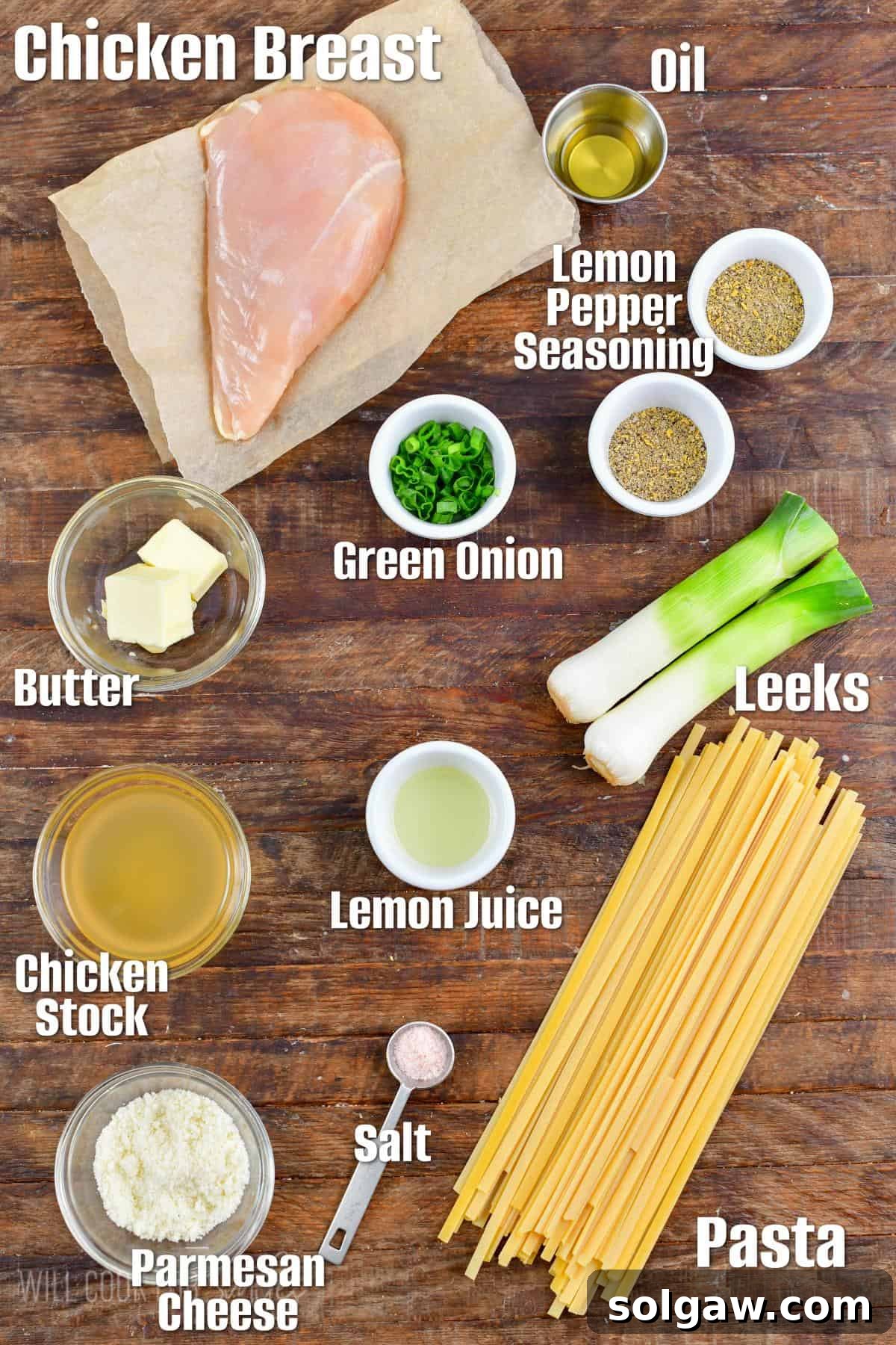 Labeled ingredients for lemon pepper chicken pasta on a wood cutting board.