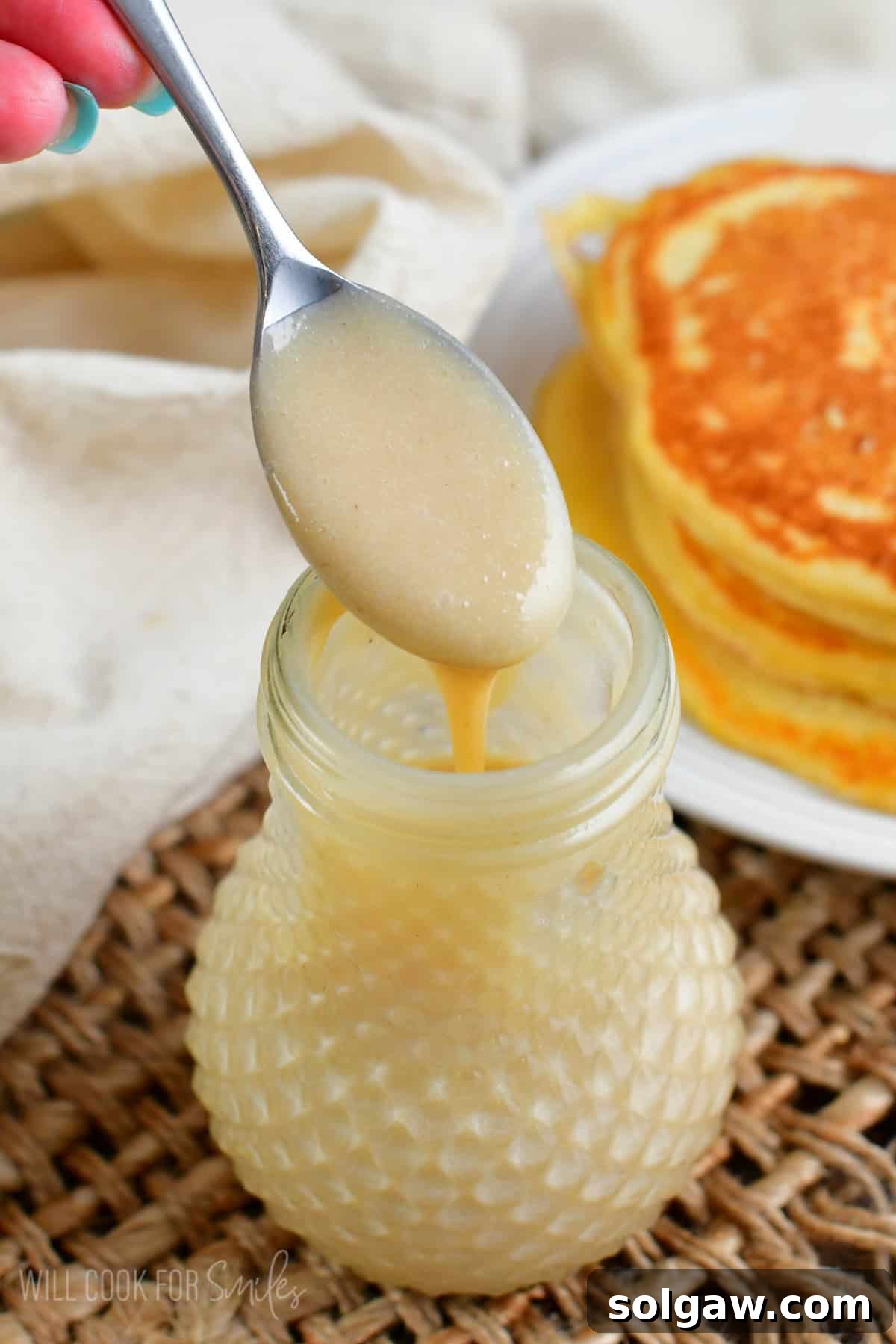 Tropical Coconut Syrup 2 spooning out some of the coconut syrup out of the jar.