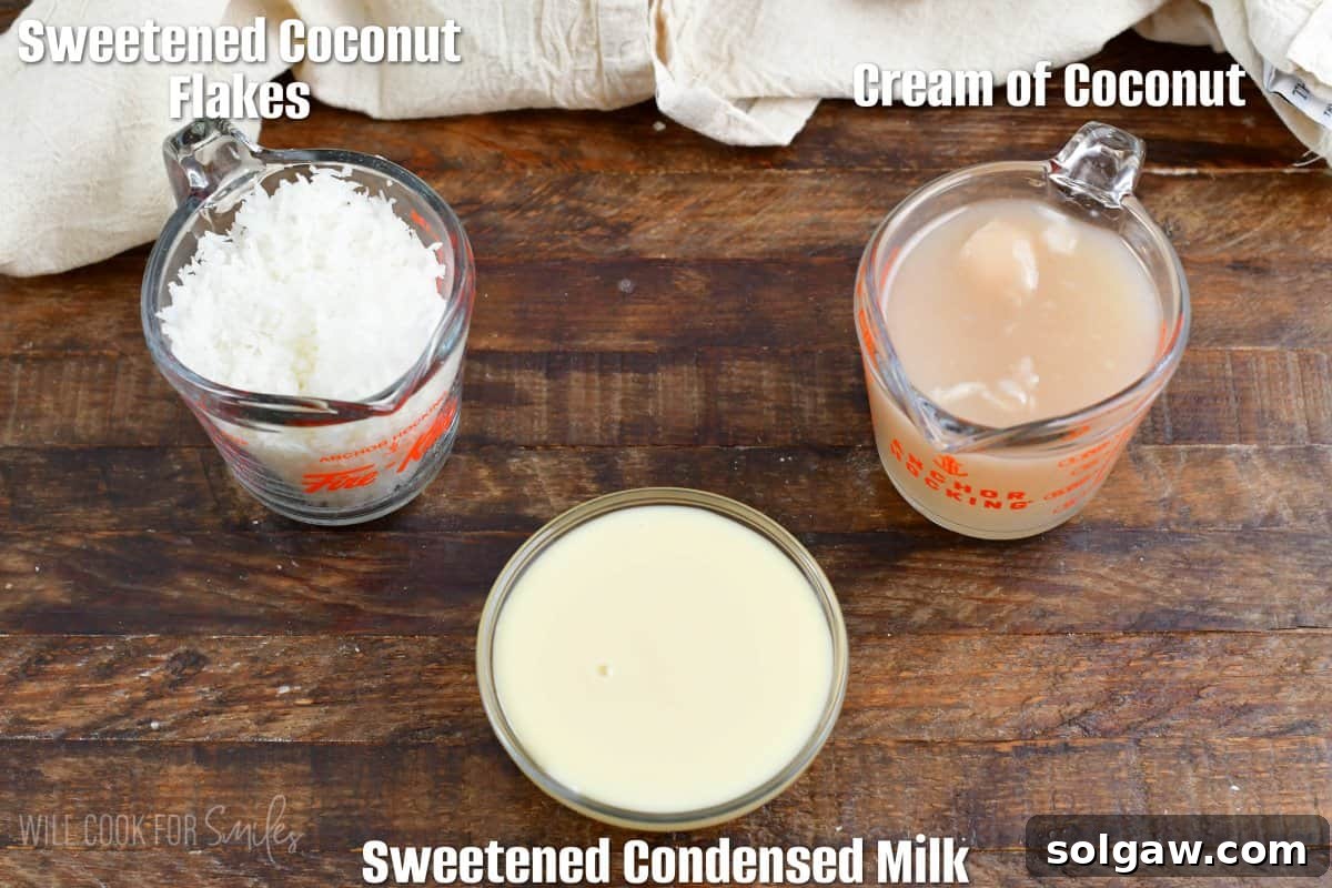 Tropical Coconut Syrup 3 labeled ingredients for coconut syrup on a wood surface.