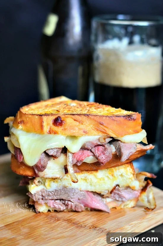 Rustic Steak Pizzaiola Linguine 14 Hearty Steak and Onion Grilled Cheese sandwich on a cutting board, showcasing melted cheese and savory steak.