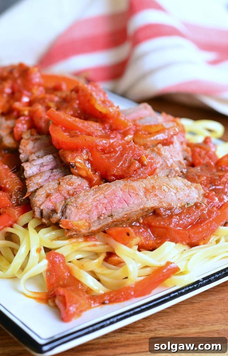 Rustic Steak Pizzaiola Linguine 8 Close-up of Steak Pizzaiola Linguine on a plate, with a focus on the rich sauce, tender steak slices, and a garnish of fresh herbs.