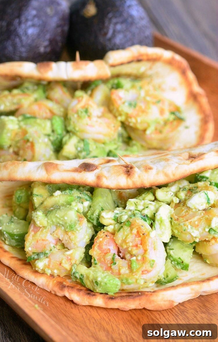 Delicious Avocado Shrimp Flatbread Sandwich presented on a wooden cutting board