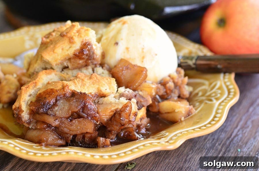 Maple Pecan Apple Cobbler Skillet with a scoop of vanilla ice cream on a yellow plate