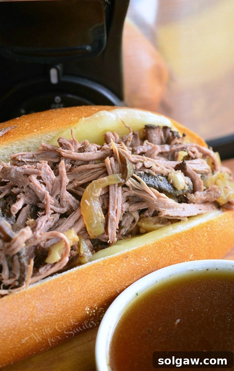 Close-up of a delicious Mushroom and Onion Italian Beef sub with au jus in a white bowl