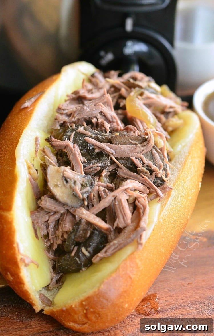 Mushroom and Onion Italian Beef sub artfully arranged on a cutting board, ready to be served