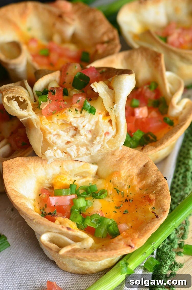 Chicken enchilada cups with stacked on top of each other with one cut in half