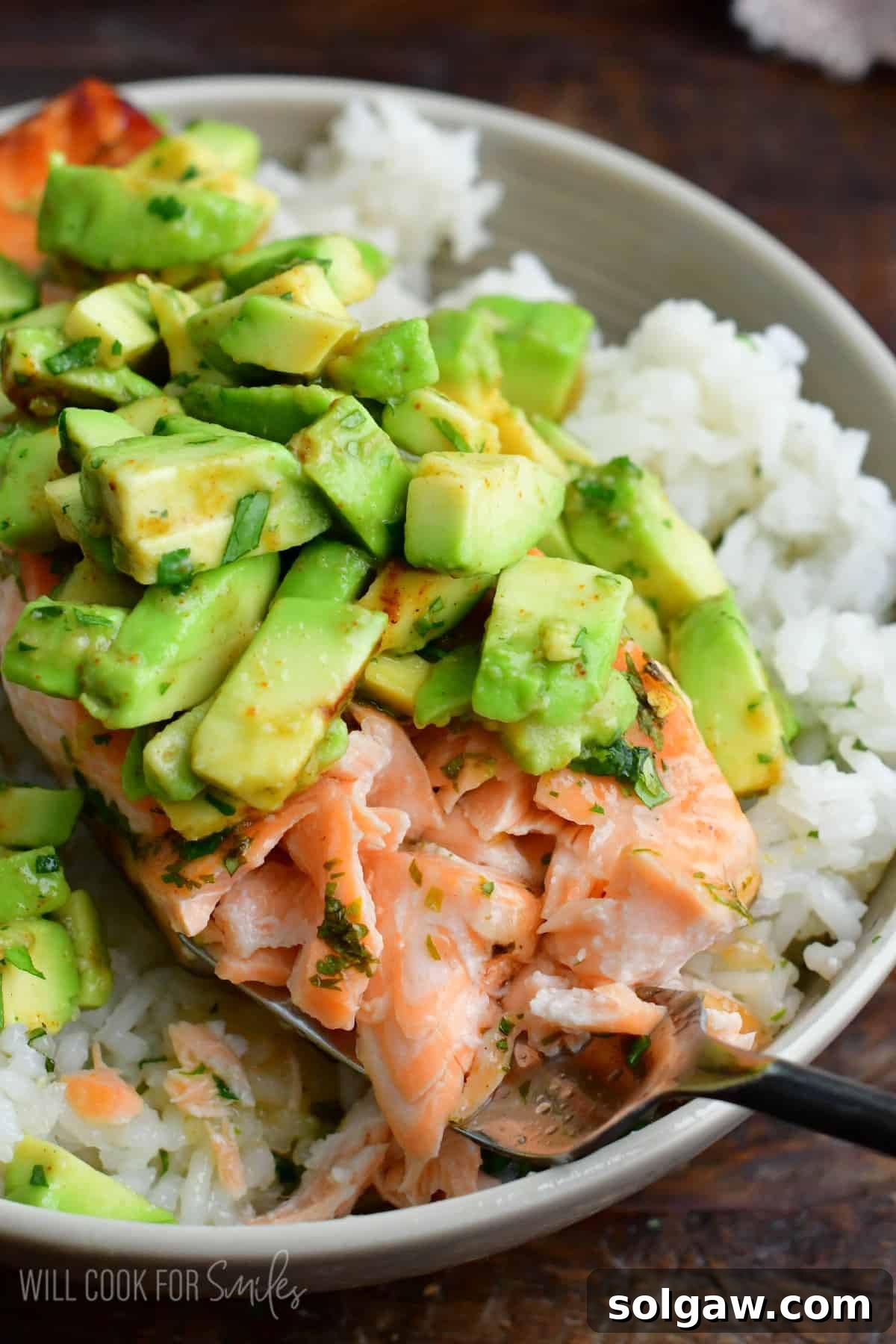 A fork gently flaking a piece of cooked salmon, showcasing its perfect texture and doneness.