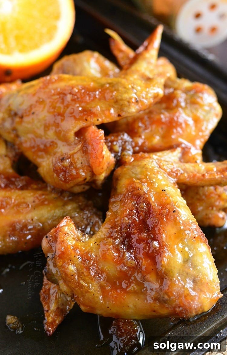 Spicy Orange Chicken Wings. Baked chicken wings slathered in an easy homemade spicy orange glaze will make any party a smash!