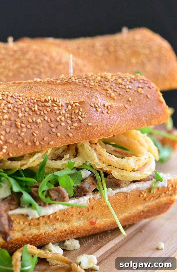 Close-up of the Onion Rings, Arugula, and Blue Cheese Steak Sandwich