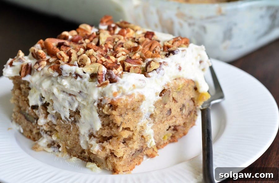 Hummingbird Poke Cake ready for serving, showcasing its rich frosting and festive topping.